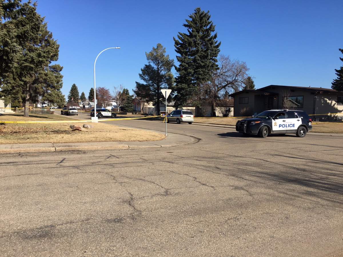 Edmonton police block off two homes and an alley near 79 Street and 143 Avenue April 23, 2018.