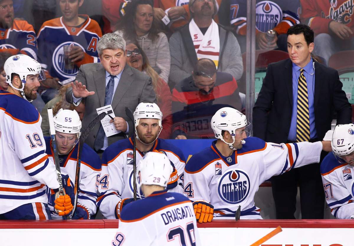 Edmonton Oilers’ coaches during a game against the Calgary Flames in Calgary, Alberta on Oct. 14, 2016. Head coach Todd McLellan, left, and assistant coach Jay Woodcroft, right.