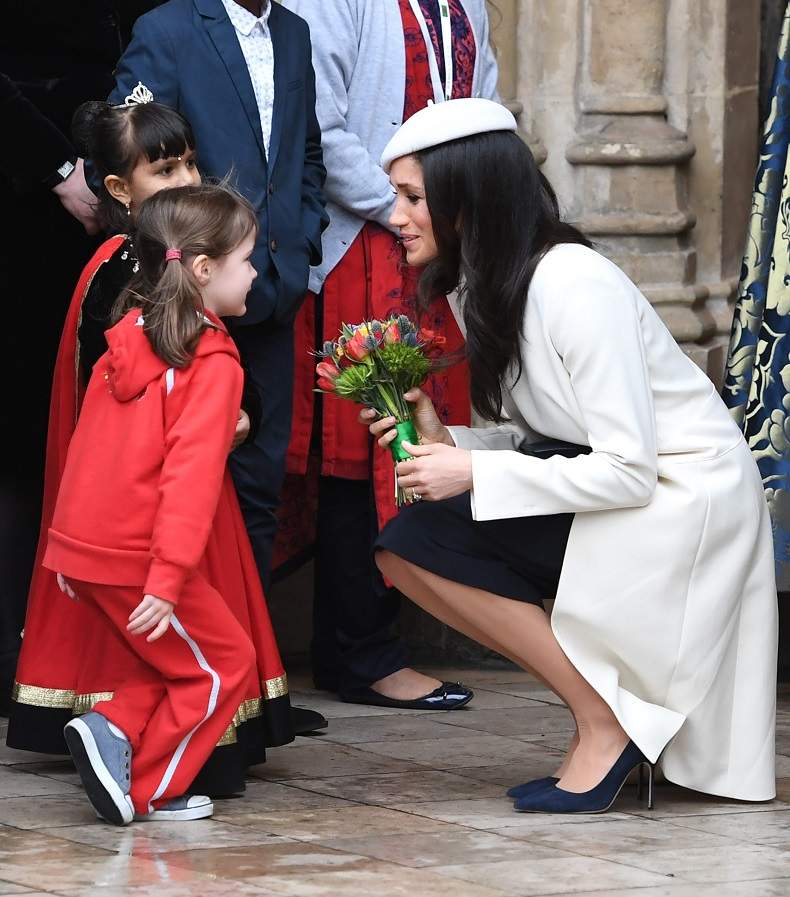 Meghan Markle speaks with a young girl following the Commonwealth Service at Westminster Abbey in London on March 12, 2018.