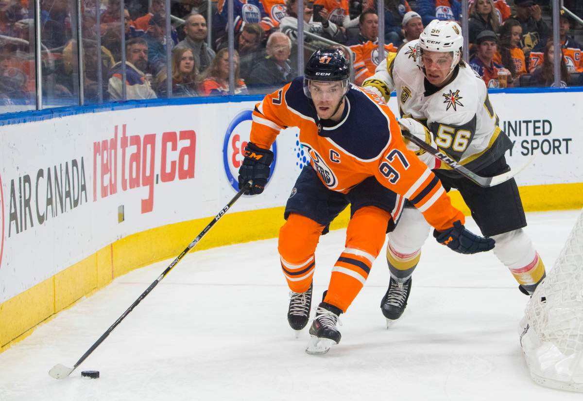 Vegas Golden Knights' Erik Haula (56) pressures Edmonton Oilers' Connor McDavid (97) during second-period NHL hockey game action in Edmonton, Alberta, Thursday, April 5, 2018. (Amber Bracken/The Canadian Press via AP).