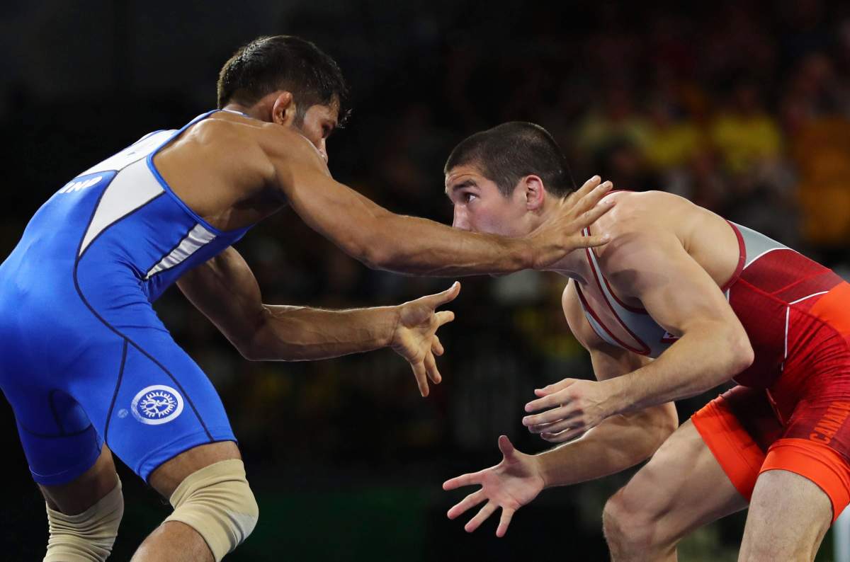 India's Rahul Aware, in blue, wrestles with Canada's Steven Takahashi to win Gold medal in men's FS 57Kg wrestling at the Commonwealth Games on Gold Coast, Australia, Thursday, April 12, 2018.