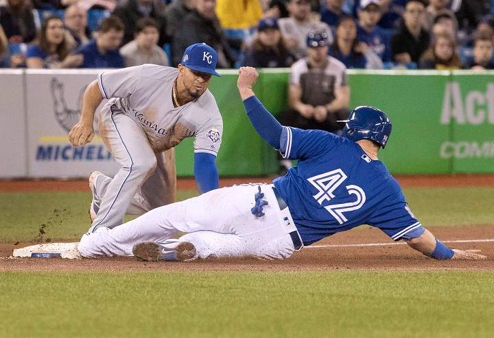 Kansas City Royals third baseman Cheslor Cuthbert puts the tag on Toronto Blue Jays' Justin Smoak for the out at third base in the sixth inning in the first game of their American League MLB baseball doubleheader in Toronto on Tuesday April 17, 2018.