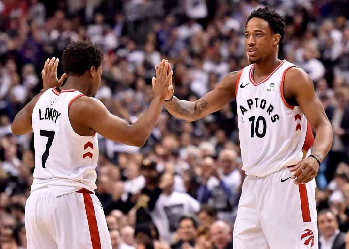 Toronto Raptors guard Kyle Lowry (7) and teammate DeMar DeRozan (10) celebrate a basket during first half NBA basketball action against the Washington Wizards, in Toronto on Tuesday.