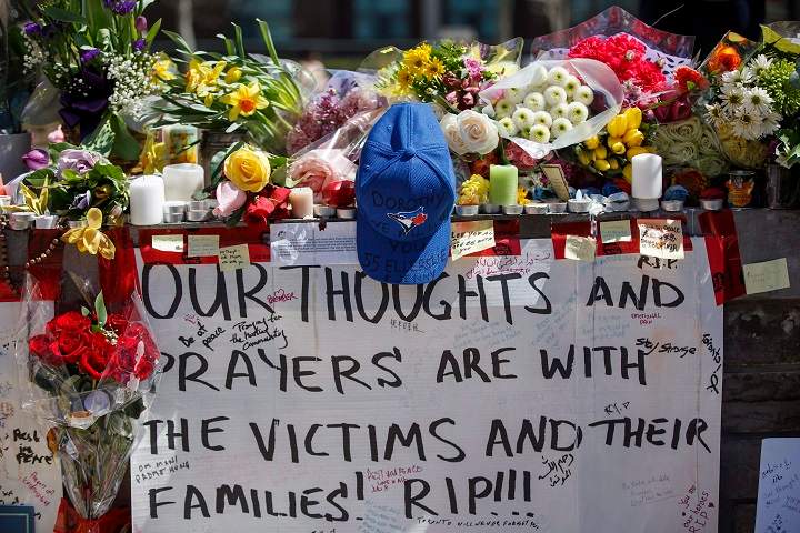 Tributes are seen on a memorial at Yonge St. and Finch Ave. in Toronto on Thursday, April 26, 2018 for the victims of Monday's deadly van attack. 