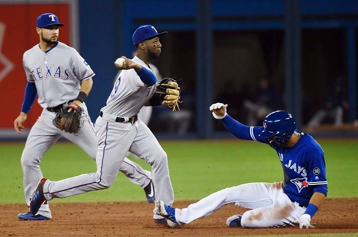 Texas Rangers shortstop Jurickson Profar (19) forces out Toronto Blue Jays second baseman Lourdes Gurriel (13) at second base during sixth inning AL baseball action in Toronto on Sunday, April 29, 2018. 