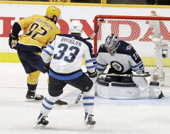 Nashville Predators center Ryan Johansen (92) scores a goal against Winnipeg Jets goalie Connor Hellebuyck (37) during the third period in Game 2 of an NHL hockey second-round playoff series, Sunday, April 29, 2018, in Nashville, Tenn.
