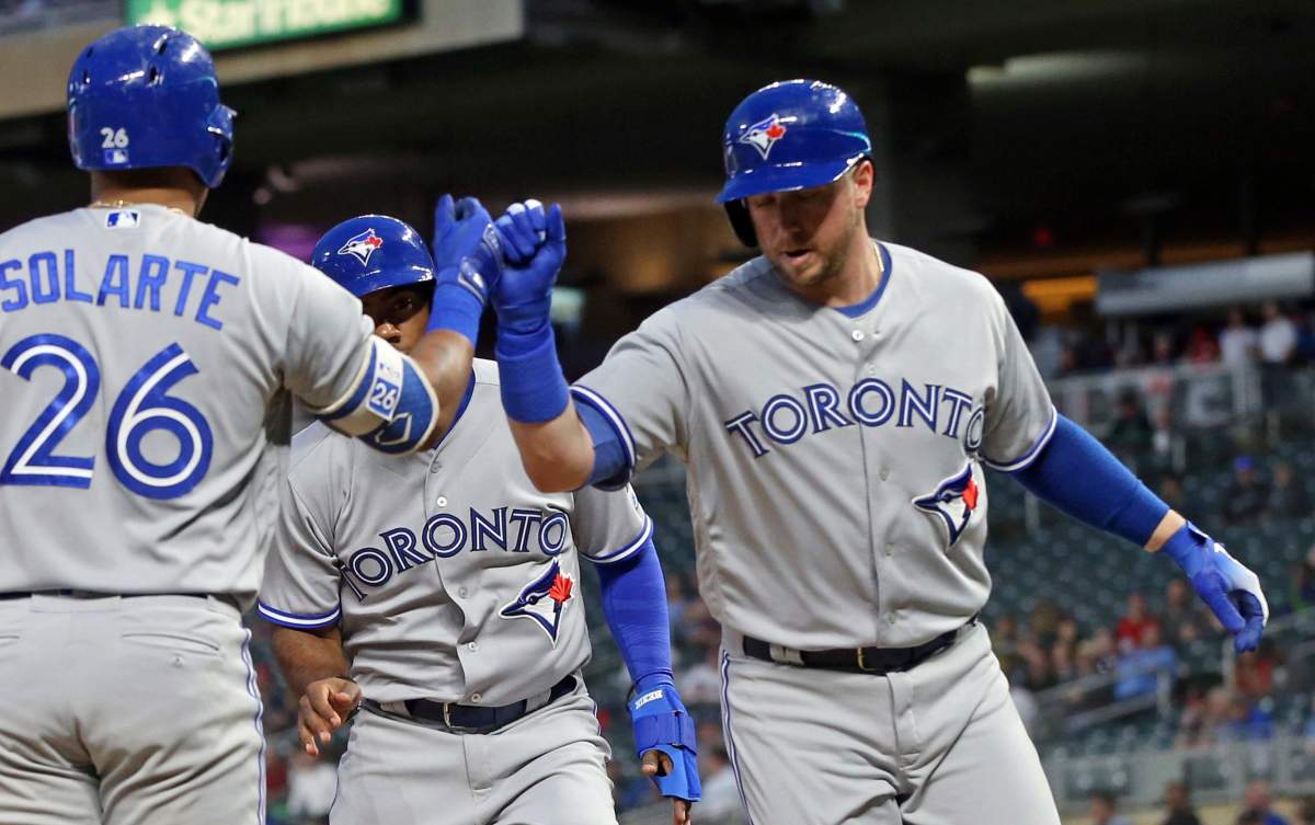 Toronto Blue Jays' Justin Smoak, right, is congratulated by Yangervis Solarte after Smoak's two-run home run off Minnesota Twins pitcher Lance Lynn in the fourth inning of a baseball game Monday, April 30, 2018, in Minneapolis.