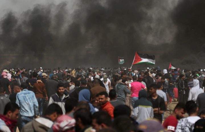 Palestinian demonstrators take part in a protest at the Israel-Gaza border on April 13.