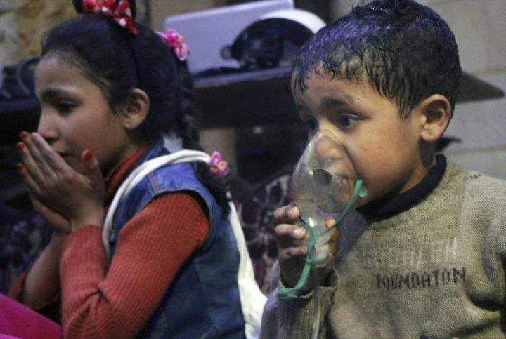 This image released early Sunday, April 8, 2018 by the Syrian Civil Defense White Helmets, shows a child receiving oxygen following an alleged poison gas attack in the rebel-held town of Douma, near Damascus, Syria.