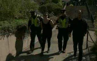 A woman is arrested in Victoria after stealing a sign at dueling rallies over the province's SOGI policy. 