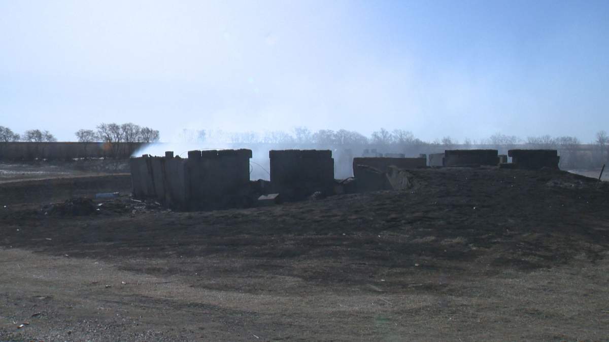 What remains of the 100-year old barn that burned down from the April 26 prairie fire .
