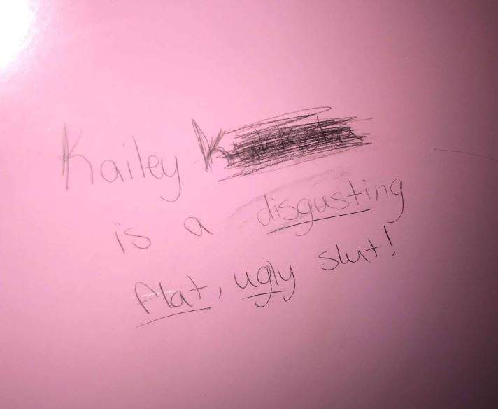 The message scrawled on the bathroom wall at school. Photo submitted.