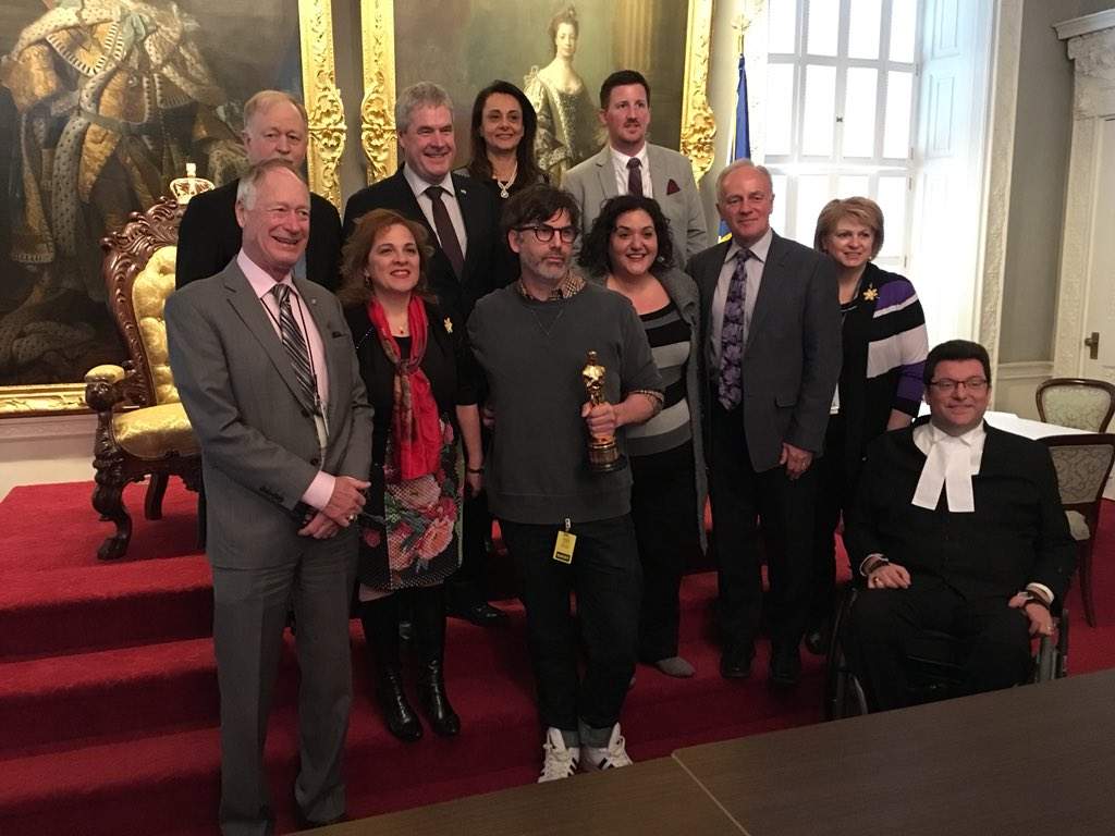 Shane Vieau, who won an Academy Award for his set design on The Shape of Water, poses with MLAs at the Nova Scotia legislature on April 4, 2019.