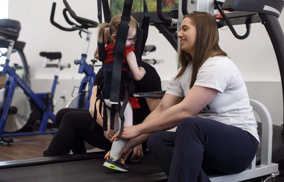 Neuro Exercise Specialist and Co-founder of ReYu, Nancy Morrow works with Evelyn Moore on the treadmill at the ReYu Paralysis Recovery Centre in Edmonton Alta, on Wednesday April 4, 2018.