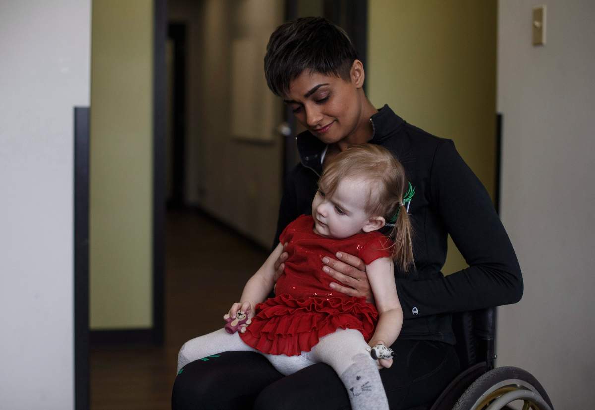 Evelyn Moore has a quiet moment with Bean Gill, co-founder of ReYu Paralysis Recovery Centre in Edmonton Alta, on Wednesday April 4, 2018.