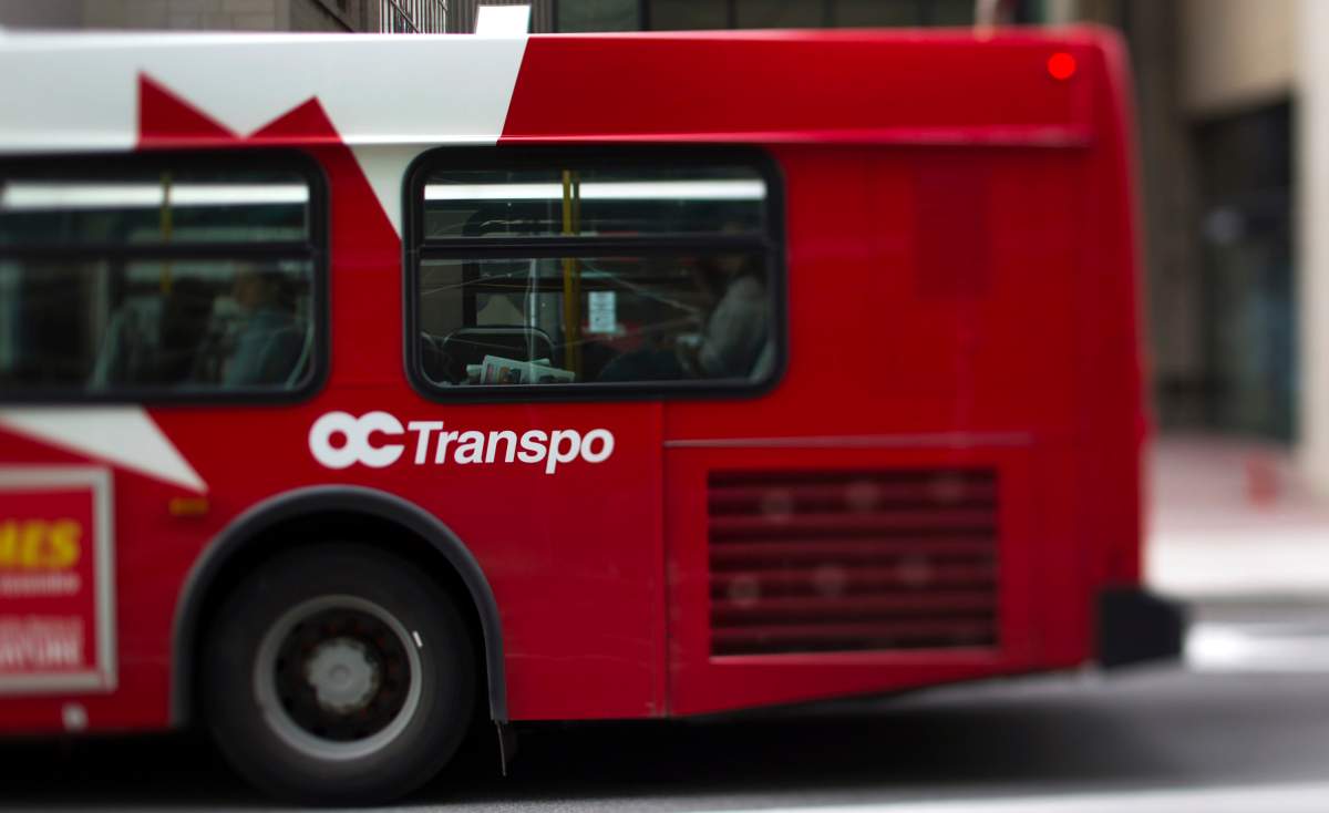 An OC Transpo bus drives down the street in this photo taken with a tilt shift lens in Ottawa, Ont., on Tuesday, Aug. 9, 2011