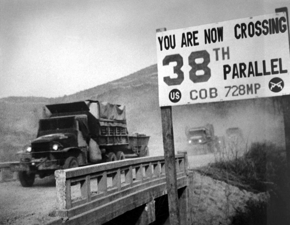 View of United Nations forces, traveling in trucks, crossing the 38th parallel as they withdraw from Pyongyang, the North Korean capital, 1950.
