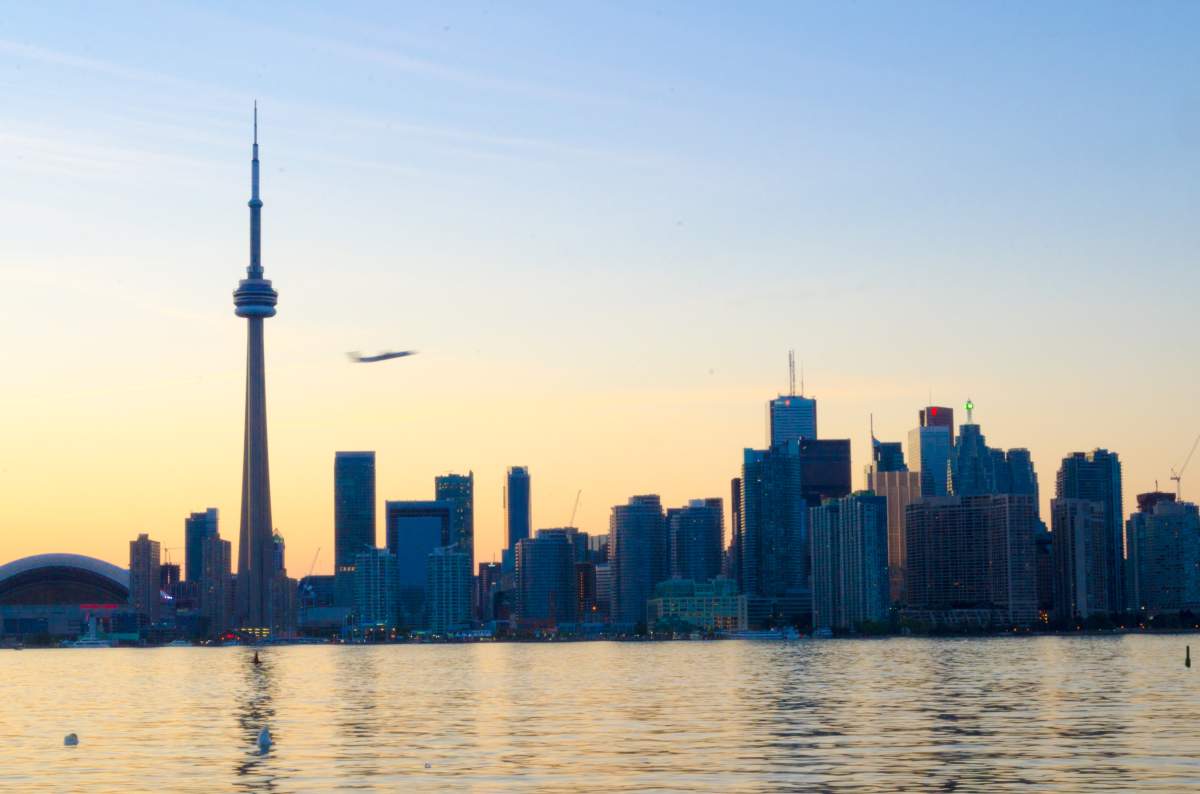 TORONTO, ONTARIO, CANADA – 2012/07/02: Toronto urban skyline including the CN Tower and plane taking off from Porter airport. The Canadian National tower is the tallest free standing structure in the Western Hemisphere and a symbol of Canada. (Photo by Roberto Machado Noa/LightRocket via Getty Images)