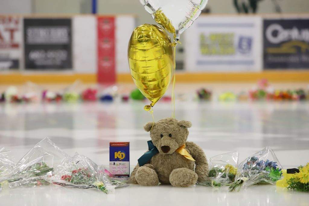 Flowers, cards and sentimental gifts adorn the ice surface at Humboldt Uniplex during preparations for a prayer vigil for the Humboldt Broncos ice hockey team, April 8, 2018, in Humboldt, Sask. (Getty Images). 