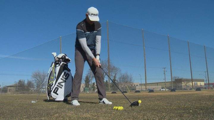 Head golf professional at Holiday Park, Brian Gabrush, tees up at the driving range.