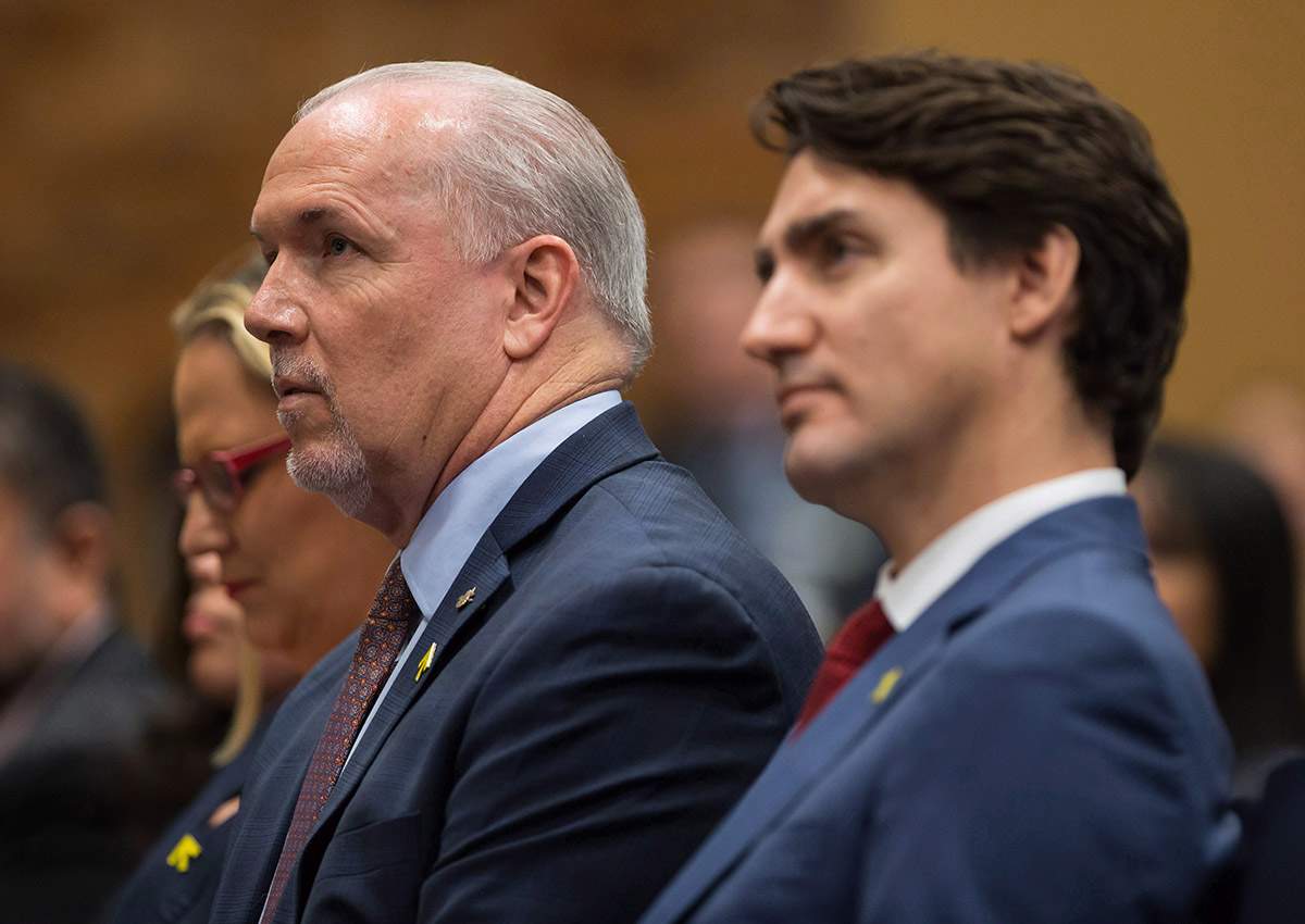 British Columbia Premier John Horgan, back left, and Prime Minister Justin Trudeau listen to his wife Sophie Gregoire Trudeau speak, at the Women Deliver kickoff event in Vancouver, B.C., on Thursday, November 16, 2017.