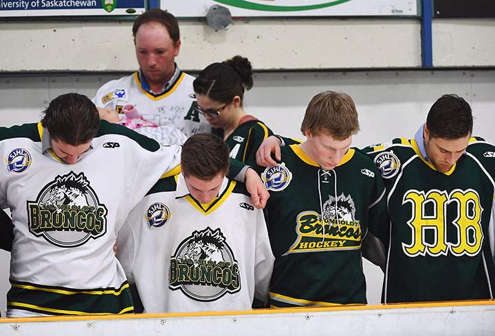 Mourners embrace each other during a moment of prayer at a vigil at the Elgar Petersen Arena, home of the Humboldt Broncos, to honour the victims of a fatal bus accident, April 8, 2018.