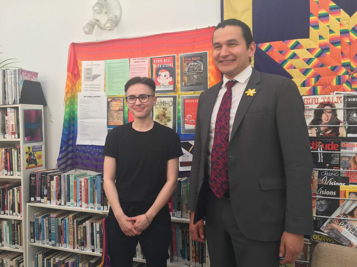 Manitoba NDP leader Wab Kinew stands with Sam MacKinnon Wednesday afternoon.