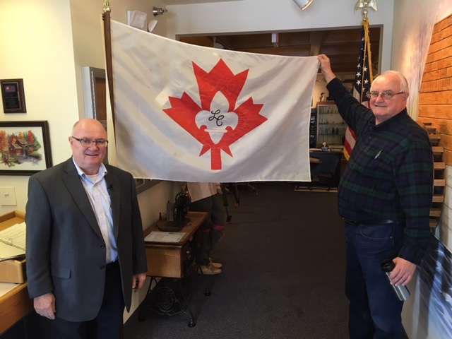 John Keis (left) is the Mayor of Little Canada. On his right is the head of the Little Canada Historical Society, Kurt Loschay, proudly showing the town flag.