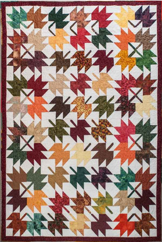 This photo shows suitable cotton fabrics for Quilts of Valour sewn in a maple leaf pattern,.