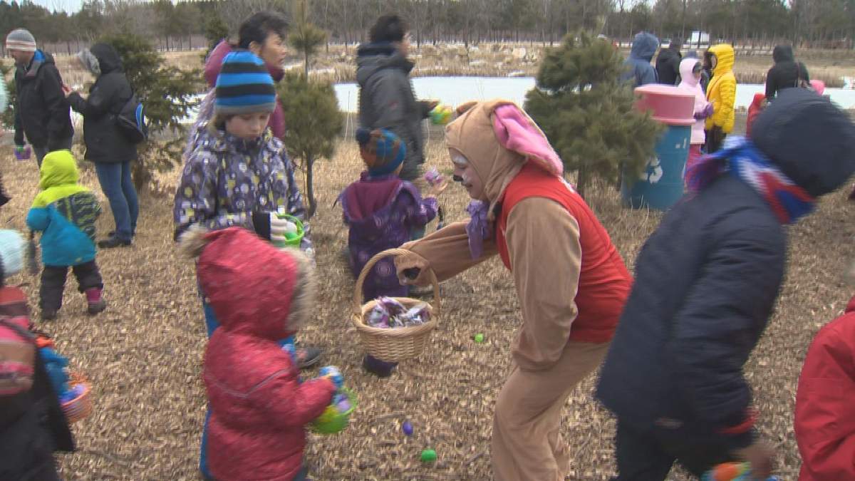 Children show their basket full of eggs to receive a chocolate treat from the Easter Bunny.