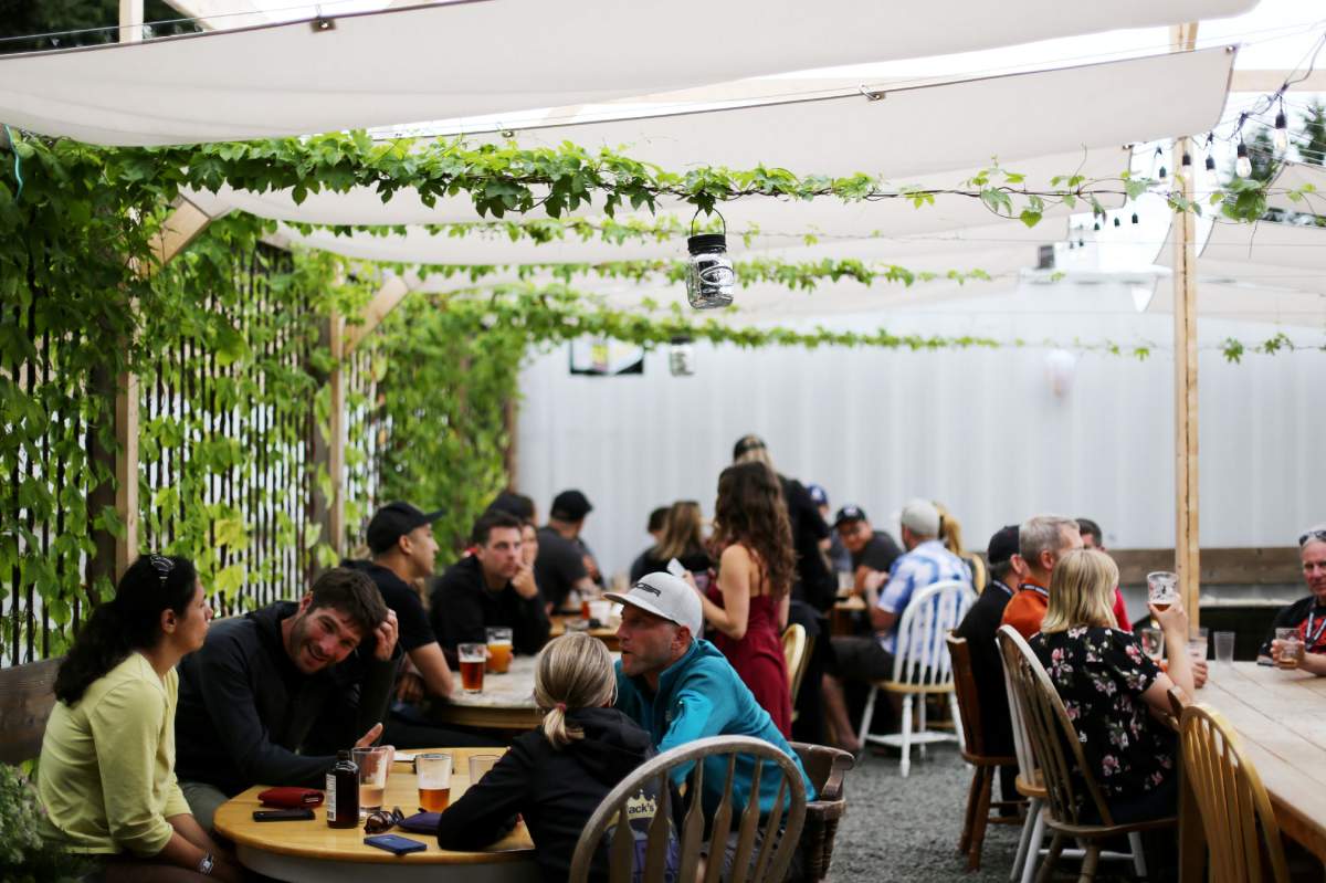 A group of people having drinks on the patio at Cumberland Brewing Co. along the Nanaimo & Comox Valley Ale Trail.