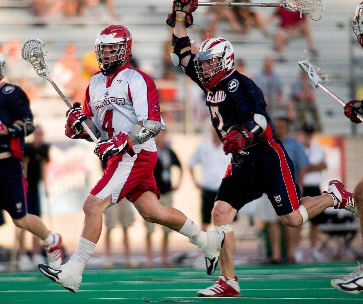 England's Alistair Wallace, right, chases Canada's Geoff Snider at the World Lacrosse Championships In London, Ontario on Tuesday July 18, 2006. Canada defeated England 17-9. (CP PHOTO/Geoff Robins).
