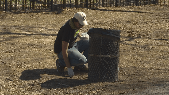 A Montreal resident picks up trash in La Fontaine Park on Earth Day. Sunday, April 22, 2018.