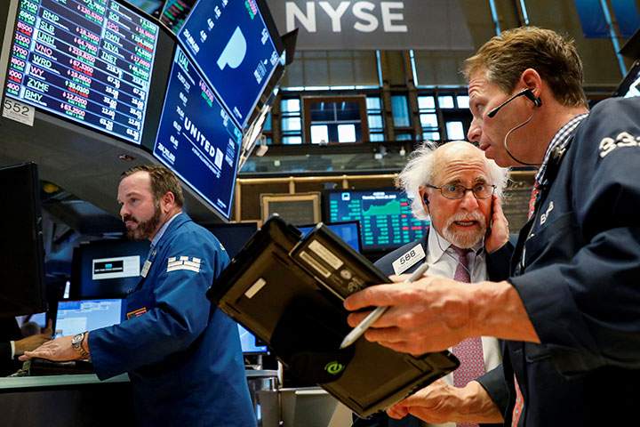 Traders work on the floor of the New York Stock Exchange on March 29, 2018. 