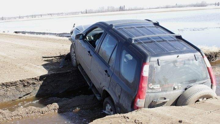 A vehicle in a washed-out section of road in Westlock County on April 23. The municipality has declared a state of local emergency.