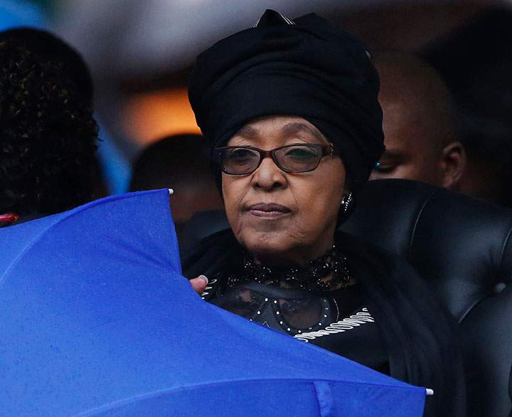 In this Dec. 10, 2013 file photo, Winnie Madikizela-Mandela listens to speeches during the memorial service for her ex-husband, former South African president Nelson Mandela at the FNB Stadium in Soweto, Johannesburg.