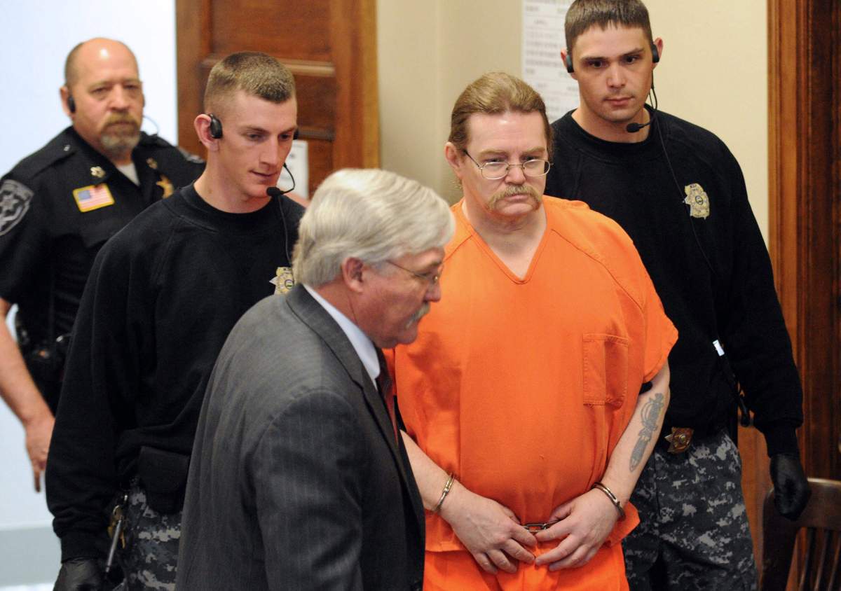 FILE - This Wednesday, May 2, 2012 file photo shows convicted murderer Ronald Smith escorted in for his clemency hearing at Powell County District Court in Deer Lodge, Mont.