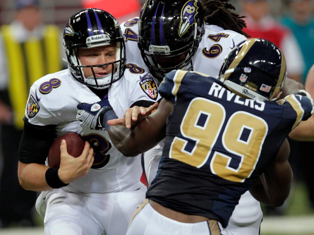 Baltimore Ravens quarterback Caleb Hanie, left, is sacked for an 8-yard loss by St. Louis Rams defensive end Gerald Rivers (99) as Ravens offensive tackle Rogers Gaines, center, tries to block Rivers during the third quarter of an NFL preseason football game Thursday, Aug. 29, 2013, in St. Louis.