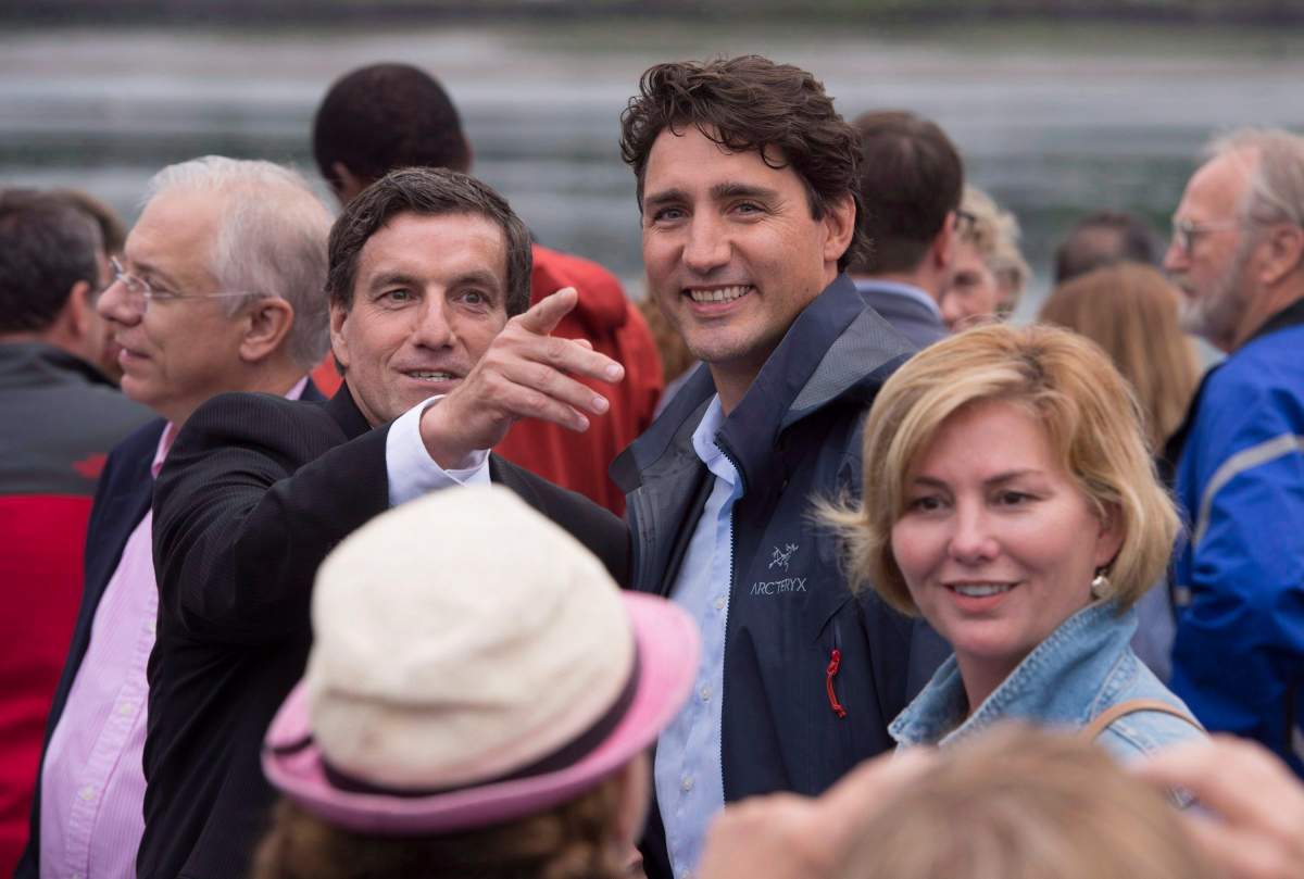 In this file photo, former Liberal MP Denis Lemieux points out a landmark to Prime Minister Justin Trudeau as he welcomed Liberal MPs to his riding of Chicoutimi-Le Fjord for a caucus meeting in 2016. Trudeau has called a byelection in the riding to replace Lemieux. Sunday, May 13, 2018.