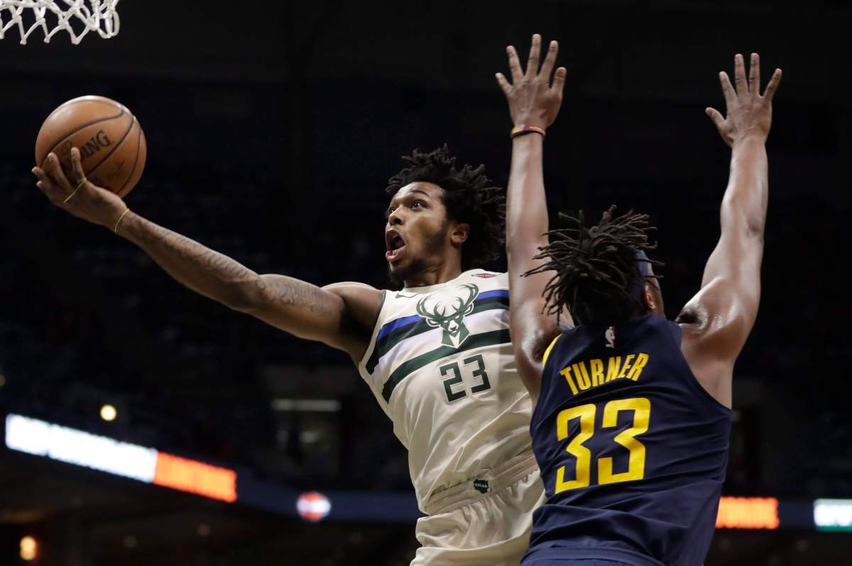 Milwaukee Bucks’ Sterling Brown shoots past Indiana Pacers’ Myles Turner during the second half of an NBA basketball game Friday, March 2, 2018, in Milwaukee. The Pacers won 103-96. (AP Photo/Morry Gash)