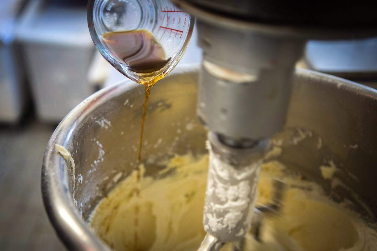A baker at Dlish Cupcakes, a bakery that uses vanilla every day, prepares the day’s first batch in Toronto on March 17, 2018.