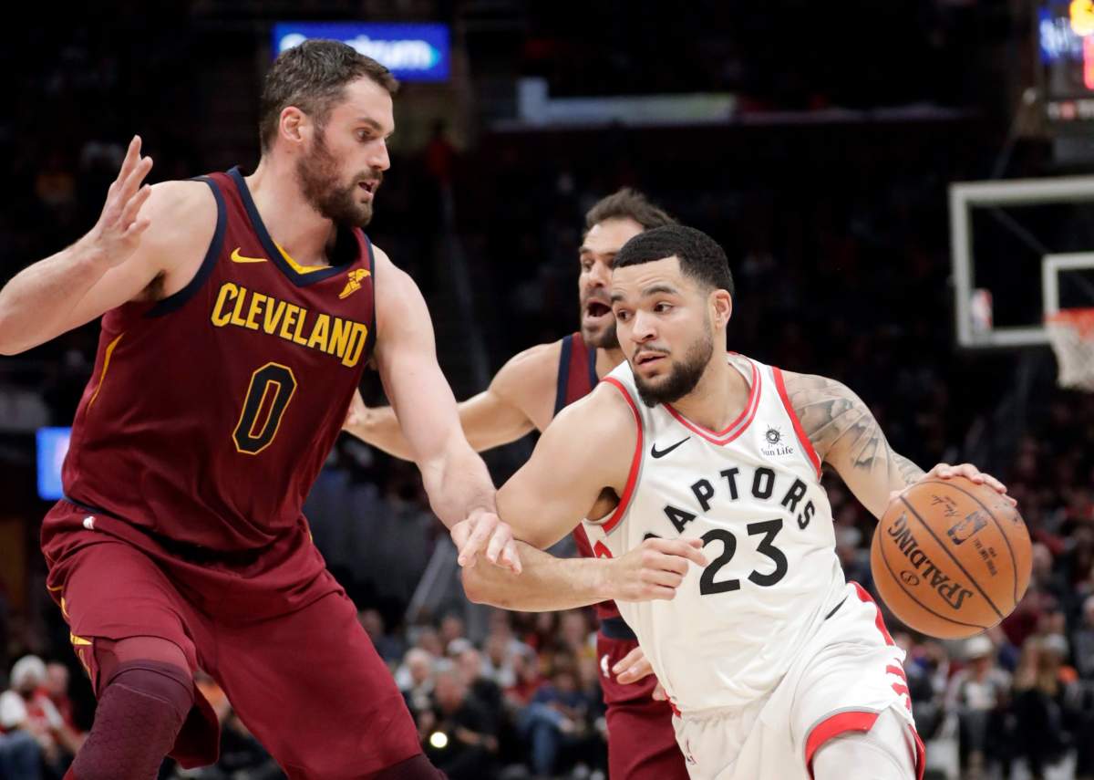 Toronto Raptors' Fred VanVleet (23) drives against Cleveland Cavaliers' Kevin Love (0) during the first half of an NBA basketball game Wednesday, March 21, 2018, in Cleveland. 