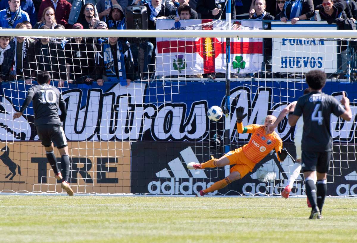 Los Angeles FC forward Carlos Vela (10) scores past Montreal Impact goalkeeper Evan Bush as Los Angeles FC defender Omar Gaber (4) looks on during second half MLS action Saturday, April 21, 2018 in Montreal. 