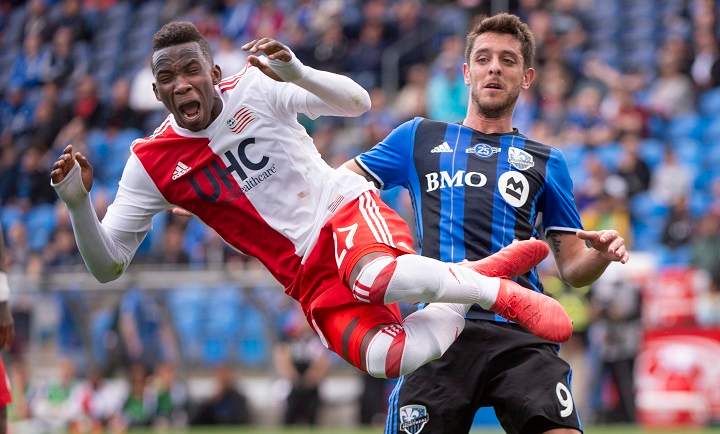 New England Revolution's Luis Caicedo leaps into the air after kicking the ball away from Montreal Impact midfielder Alejandro Silva during second half MLS action Saturday, May 5, 2018 in Montreal. 