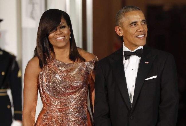 In this Oct. 8, 2016 file photo, President Barack Obama and first lady Michelle Obama wait to greet Italian Prime Minister Matteo Renzi and his wife Agnese Landini for a State Dinner at the White House in Washington. 

