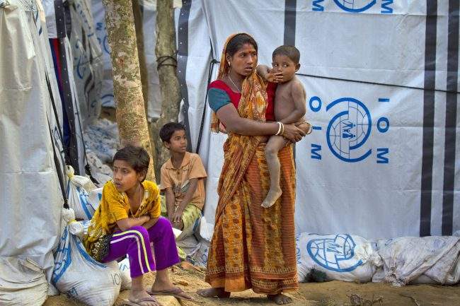 A Hindu refugee stands outside her makeshift shelter with her children in a refugee camp near Cox’s Bazar, Bangladesh, Jan. 16, 2018.