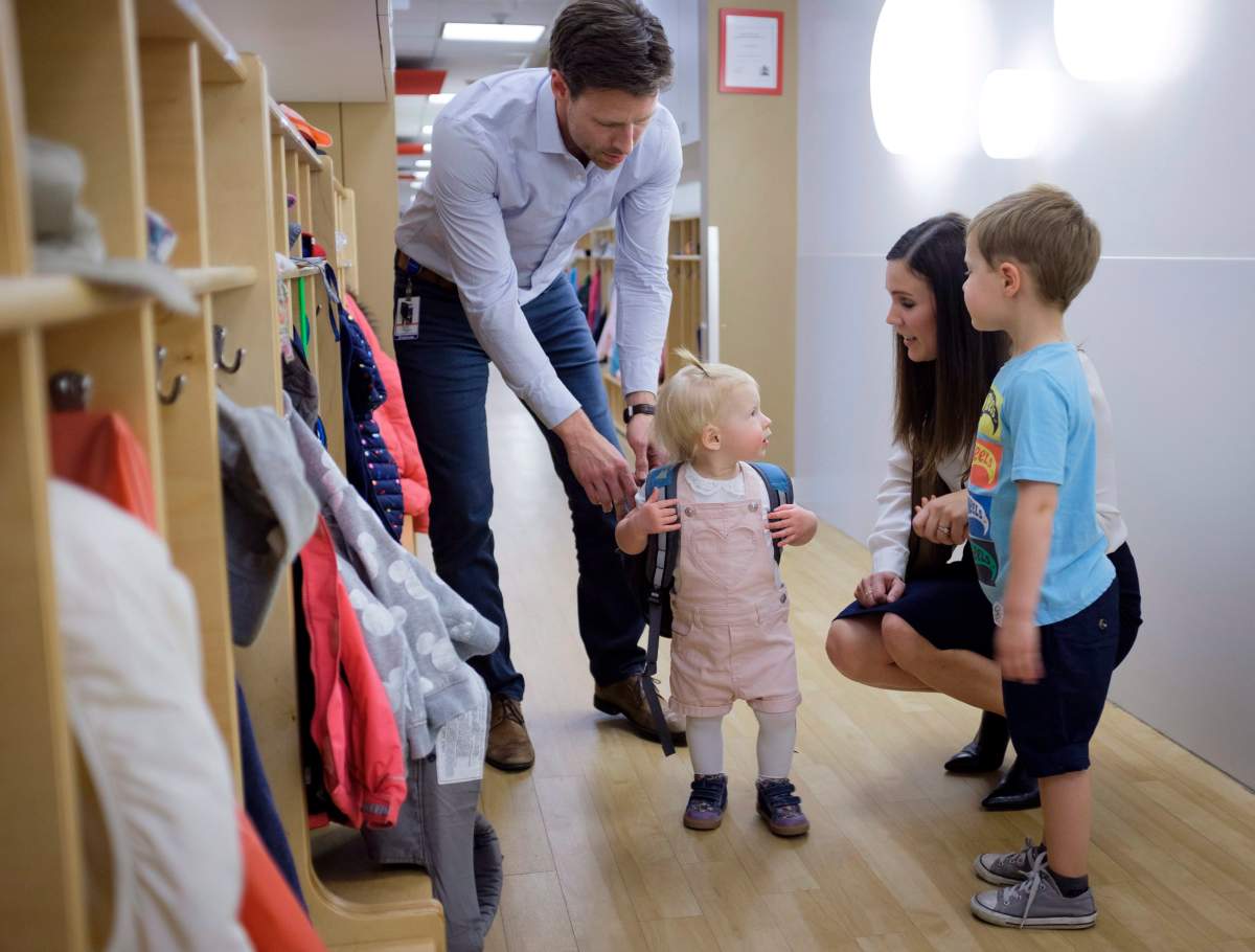 Suncor employees Jenna Pickering, and her husband Shea, pick up their children, Hannah and Luke from the Suncor daycare in Calgary, Alta., Friday, May 25, 2018.