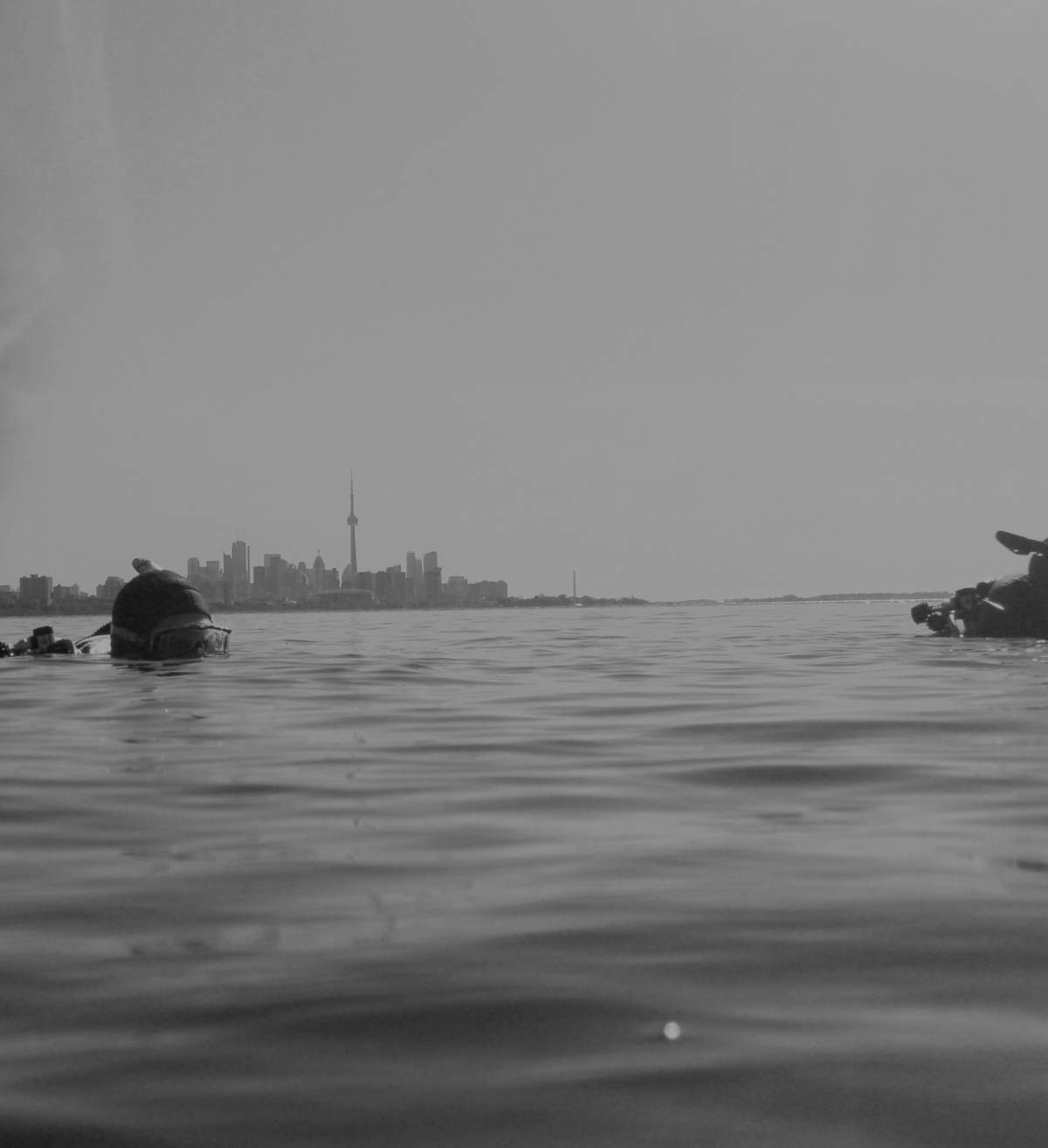 Two scuba divers prepare to descend into Lake Ontario by Humber Bay Park West in Toronto. The water temperature averages 15 C, so special gear is needed. June 14, 2017.
