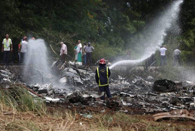 Firefighters work in the wreckage in the agricultural area of Boyeros, around 20 km south of Havana, Cuba, May 18, 2018.
