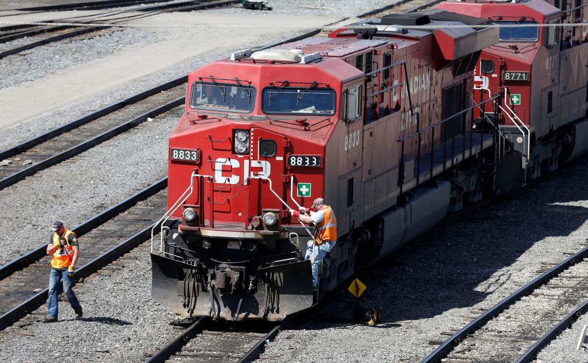 FILE — A Canadian Pacific Railway crew works on their train at the CP Rail yards in Calgary, Alberta.